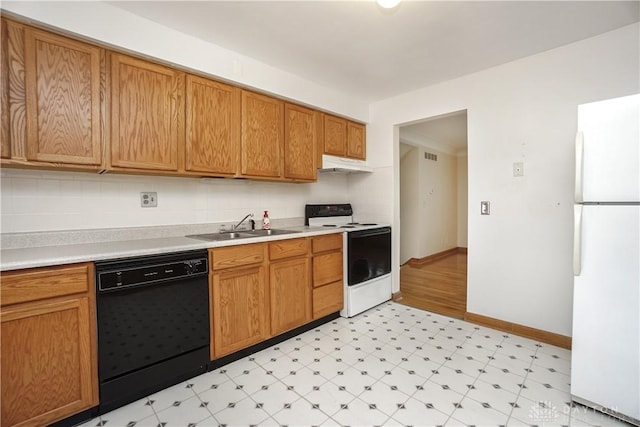 702 W Sharon Rd, Forest Park, OH 45240 - kitchen featuring white appliances, under cabinet range hood, light floors, light countertops, and brown cabinets