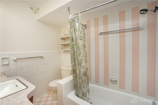 702 W Sharon Rd, Forest Park, OH 45240 - full bathroom with shower / tub combo, tile walls, vanity, a wainscoted wall, and tile patterned flooring