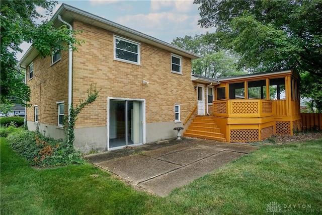 702 W Sharon Rd, Forest Park, OH 45240 - back of property with a lawn, brick siding, a patio area, and a wooden deck