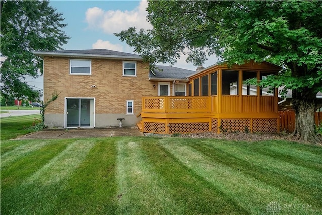 702 W Sharon Rd, Forest Park, OH 45240 - rear view of property with a sunroom, a lawn, brick siding, and a wooden deck