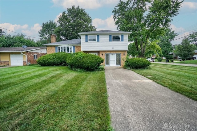702 W Sharon Rd, Forest Park, OH 45240 - split level home with brick siding, a front yard, and a chimney