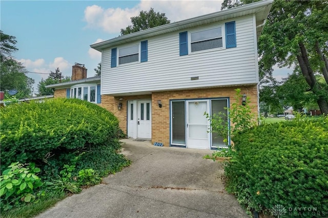 702 W Sharon Rd, Forest Park, OH 45240 - view of front facade featuring brick siding and a chimney