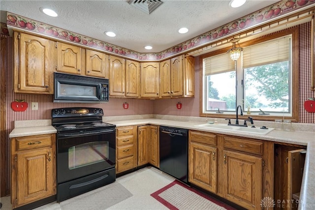 789 W Krepps Rd, Xenia, OH 45385 - kitchen with black appliances, a textured ceiling, light countertops, brown cabinets, and recessed lighting