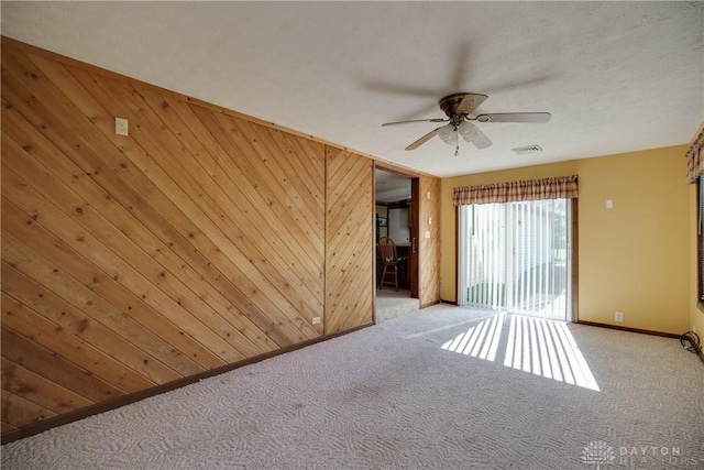 789 W Krepps Rd, Xenia, OH 45385 - carpeted empty room featuring a ceiling fan and wood walls