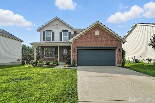 171 Shanda Dr, Monroe, OH 45050 - traditional home with covered porch, brick siding, driveway, and a front yard
