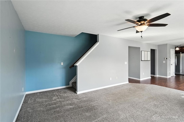 171 Shanda Dr, Monroe, OH 45050 - unfurnished living room with dark carpet, ceiling fan, and stairway