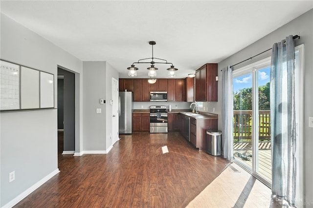 171 Shanda Dr, Monroe, OH 45050 - kitchen with appliances with stainless steel finishes, dark wood-style floors, light countertops, and pendant lighting