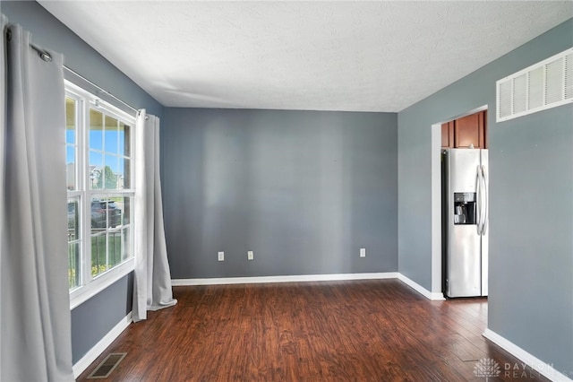 171 Shanda Dr, Monroe, OH 45050 - unfurnished room with dark wood-style floors, plenty of natural light, and a textured ceiling