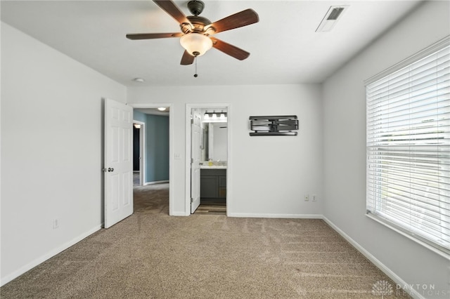 171 Shanda Dr, Monroe, OH 45050 - unfurnished bedroom with carpet, multiple windows, ensuite bathroom, and a ceiling fan