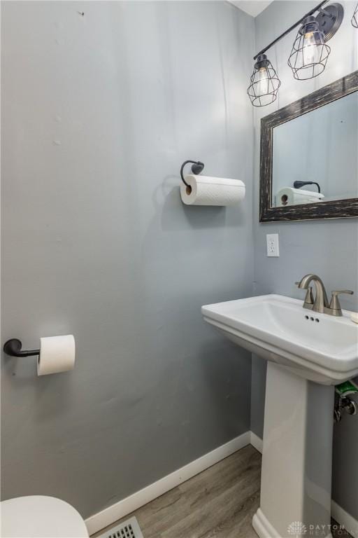 6235 Pheasant Hill Rd, Dayton, OH 45424 - half bath with wood finished floors and toilet