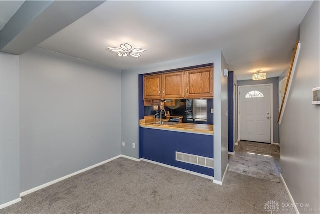 6235 Pheasant Hill Rd, Dayton, OH 45424 - kitchen with carpet, brown cabinets, and light countertops