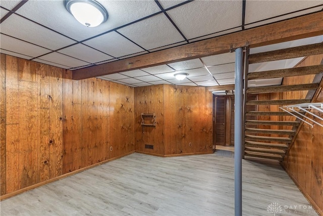 6235 Pheasant Hill Rd, Dayton, OH 45424 - finished below grade area with light wood finished floors, a drop ceiling, wood walls, and stairway
