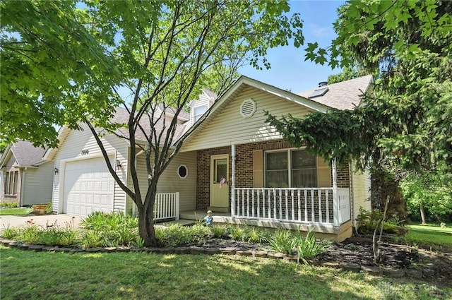 500 Smalley Blvd, Hamilton, OH 45013 - view of front of house featuring covered porch, a garage, concrete driveway, and brick siding