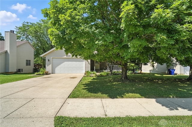 500 Smalley Blvd, Hamilton, OH 45013 - view of property hidden behind natural elements with concrete driveway, a front yard, and an attached garage