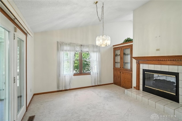 500 Smalley Blvd, Hamilton, OH 45013 - unfurnished living room with lofted ceiling, carpet flooring, a tiled fireplace, and a chandelier