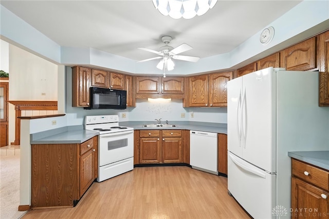 500 Smalley Blvd, Hamilton, OH 45013 - kitchen featuring white appliances, brown cabinets, light wood-style flooring, and ceiling fan