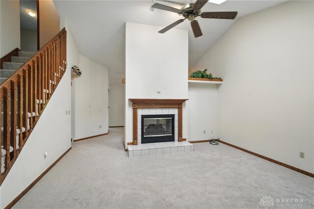 500 Smalley Blvd, Hamilton, OH 45013 - unfurnished living room featuring carpet, a ceiling fan, a tile fireplace, stairs, and lofted ceiling