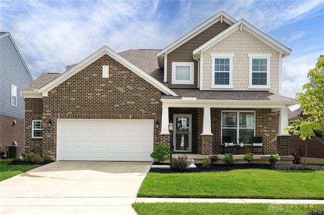 598 Twilight Ln, Dayton, OH 45440 - craftsman-style house featuring a porch, brick siding, a front yard, concrete driveway, and an attached garage