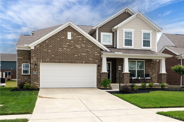 598 Twilight Ln, Dayton, OH 45440 - craftsman house with brick siding, covered porch, a front yard, and driveway