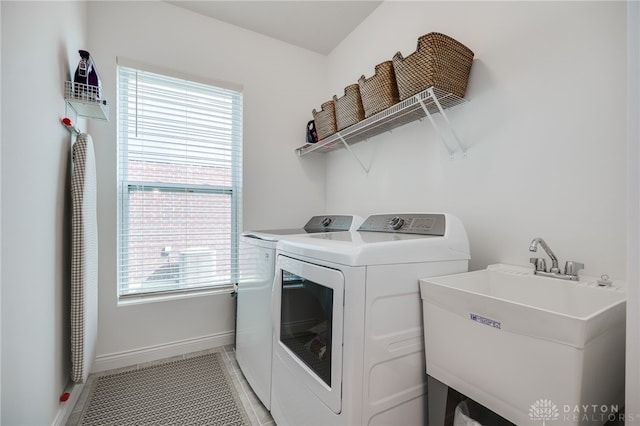 598 Twilight Ln, Dayton, OH 45440 - washroom featuring separate washer and dryer, plenty of natural light, and light tile patterned floors