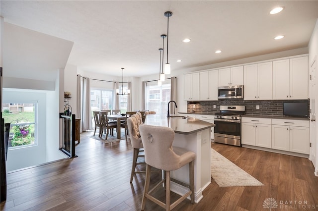 598 Twilight Ln, Dayton, OH 45440 - kitchen featuring stainless steel appliances, tasteful backsplash, dark wood finished floors, white cabinets, and recessed lighting
