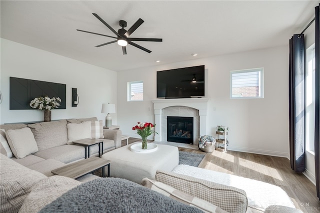598 Twilight Ln, Dayton, OH 45440 - living room featuring wood finished floors, healthy amount of natural light, a ceiling fan, a glass covered fireplace, and recessed lighting