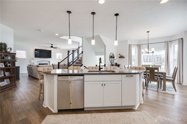 598 Twilight Ln, Dayton, OH 45440 - kitchen with dishwasher, a ceiling fan, wood finished floors, a fireplace, and decorative light fixtures