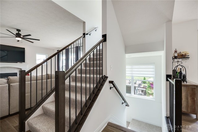 598 Twilight Ln, Dayton, OH 45440 - stairway featuring wood finished floors, a ceiling fan, and a fireplace