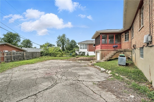 6101 Capri Dr, Cincinnati, OH 45224 - view of patio / terrace with a sunroom, stairway, and driveway