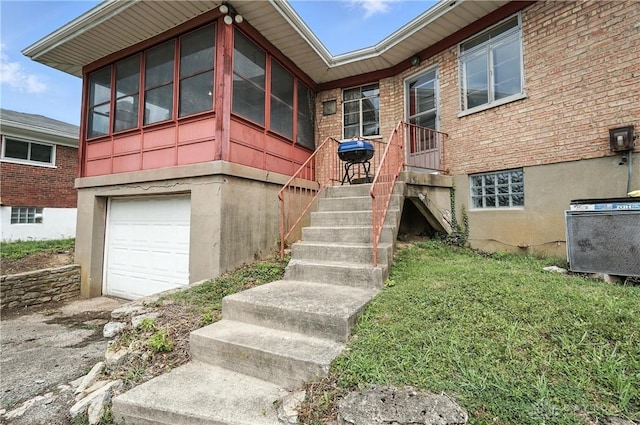 6101 Capri Dr, Cincinnati, OH 45224 - entrance to property featuring a garage and brick siding