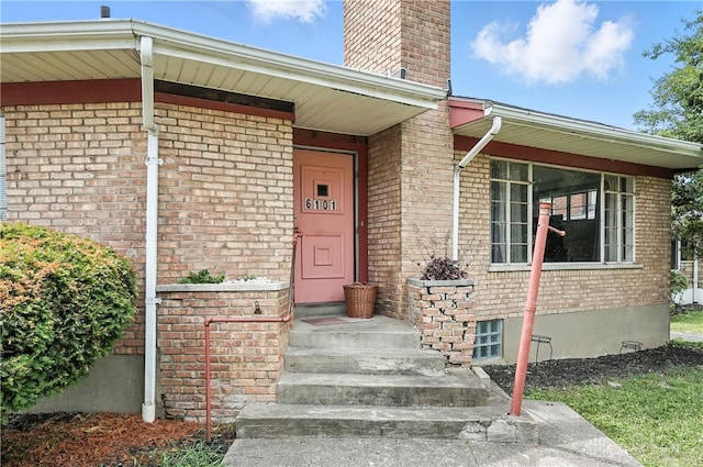 6101 Capri Dr, Cincinnati, OH 45224 - view of exterior entry featuring brick siding and a chimney