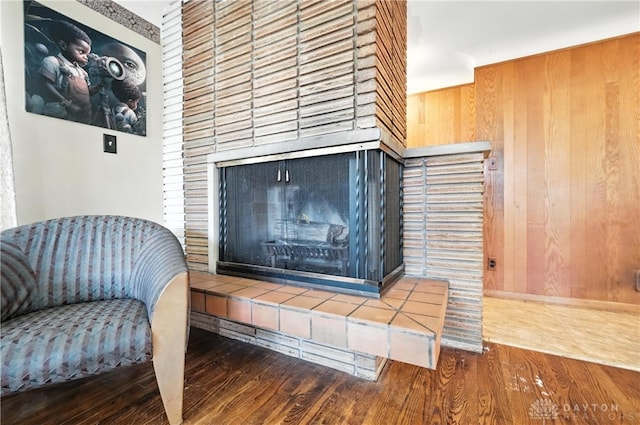 6101 Capri Dr, Cincinnati, OH 45224 - detailed view of wood finished floors, a tile fireplace, and wood walls