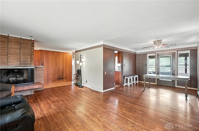 6101 Capri Dr, Cincinnati, OH 45224 - living area with a brick fireplace, ceiling fan, and wood finished floors
