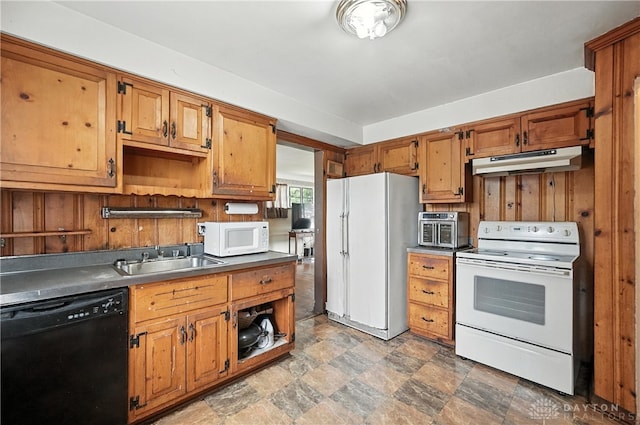 6101 Capri Dr, Cincinnati, OH 45224 - kitchen with white appliances, under cabinet range hood, stone finish floors, brown cabinets, and dark countertops