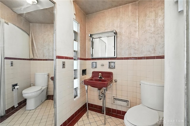6101 Capri Dr, Cincinnati, OH 45224 - full bathroom with tile patterned flooring, tile walls, and a wainscoted wall