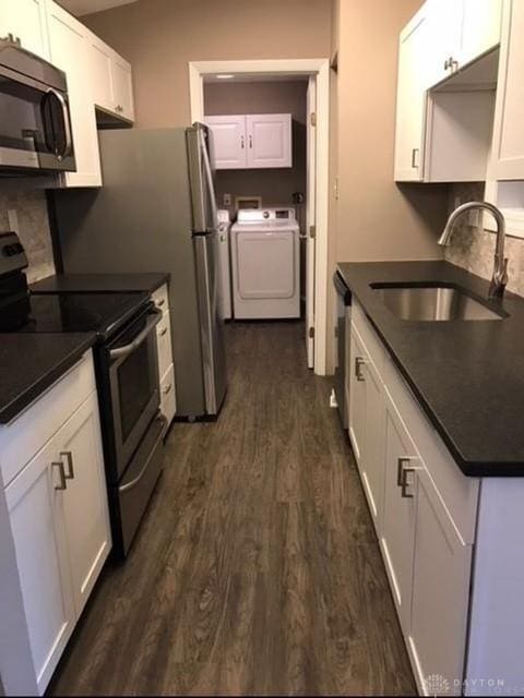 1411 Lake Pointe Way Unit 8, Washington Twp, OH 45459 - kitchen with stainless steel appliances, dark countertops, dark wood finished floors, white cabinetry, and washing machine and clothes dryer