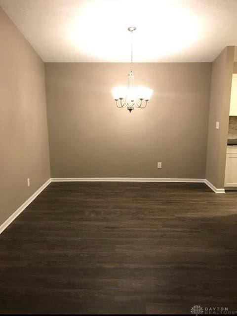 1411 Lake Pointe Way Unit 8, Washington Twp, OH 45459 - unfurnished dining area with dark wood-type flooring and a chandelier