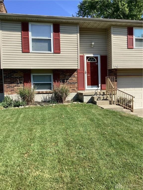 150 Lexington Farm Rd, Englewood, OH 45322 - raised ranch with brick siding, a front yard, an attached garage, and driveway
