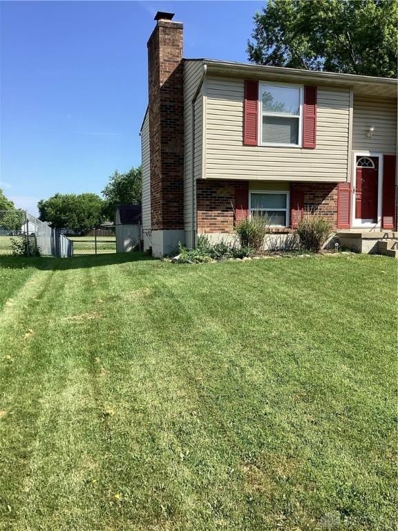 150 Lexington Farm Rd, Englewood, OH 45322 - view of side of home with a chimney and brick siding