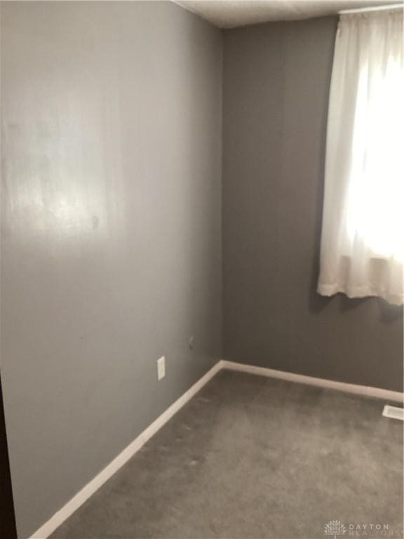150 Lexington Farm Rd, Englewood, OH 45322 - spare room featuring dark colored carpet and baseboards