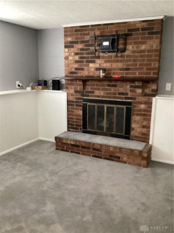 150 Lexington Farm Rd, Englewood, OH 45322 - unfurnished living room with carpet flooring, a brick fireplace, and a textured ceiling