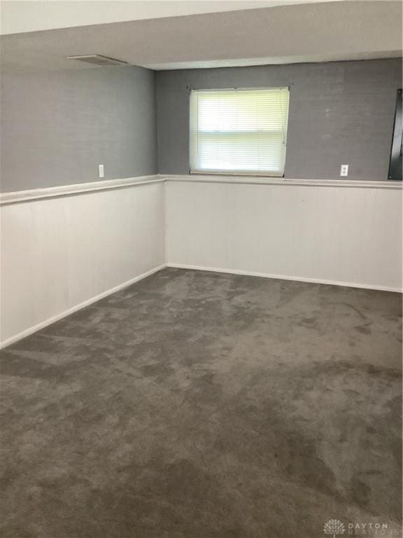 150 Lexington Farm Rd, Englewood, OH 45322 - below grade area with a wainscoted wall and dark colored carpet