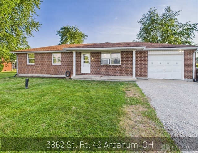 3862 State Route 49, Arcanum, OH 45304 - ranch-style house with a garage, a front lawn, brick siding, and gravel driveway