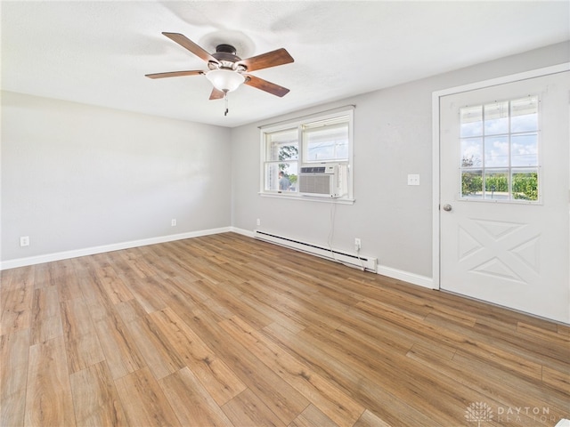 3862 State Route 49, Arcanum, OH 45304 - empty room with a baseboard heating unit, cooling unit, light wood finished floors, and ceiling fan