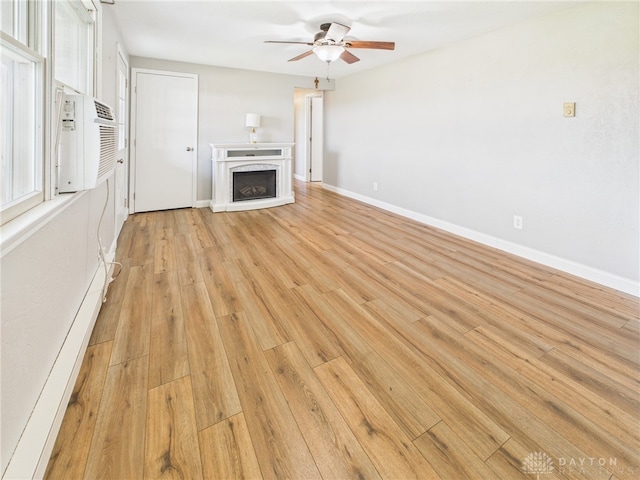3862 State Route 49, Arcanum, OH 45304 - unfurnished living room featuring ceiling fan, a fireplace, and light wood-type flooring