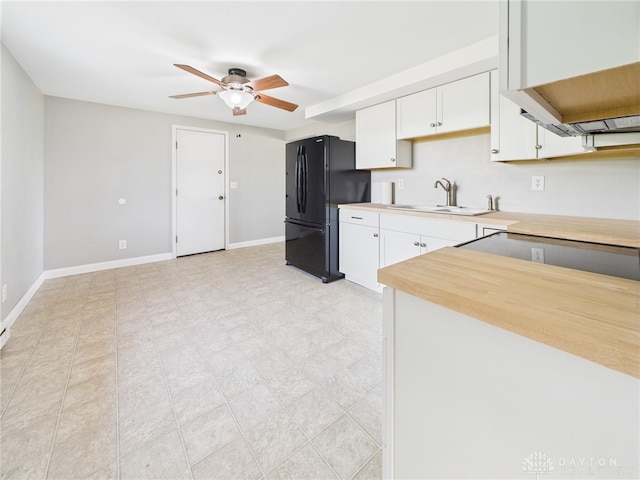 3862 State Route 49, Arcanum, OH 45304 - kitchen featuring freestanding refrigerator, light countertops, a ceiling fan, and white cabinets