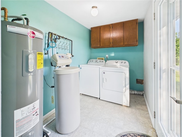 3862 State Route 49, Arcanum, OH 45304 - washroom featuring electric water heater, cabinet space, and washing machine and dryer