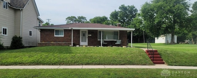 612 E Market St, Xenia, OH 45385 - view of front of home with a front yard, brick siding, and a chimney