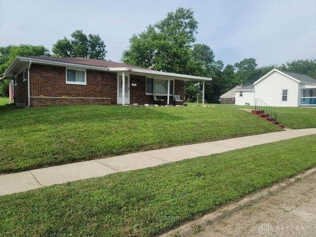612 E Market St, Xenia, OH 45385 - ranch-style home with brick siding and a front lawn