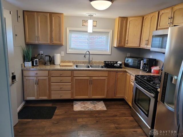 612 E Market St, Xenia, OH 45385 - kitchen with appliances with stainless steel finishes, light brown cabinetry, dark wood finished floors, and light countertops